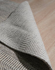 Trendy Dahlia Beige Handmade Wool Rug, soft beige wool underfoot, a modern floral dahlia pattern unfolds, crafted with a luxurious handmade feel, inviting warmth to any space.