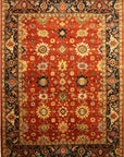 Isolated view: Kira Zinnia Rust Hand Knotted Wool Rug bursts with floral energy, rust and cream blossoms unfurling across a textured wool field.
