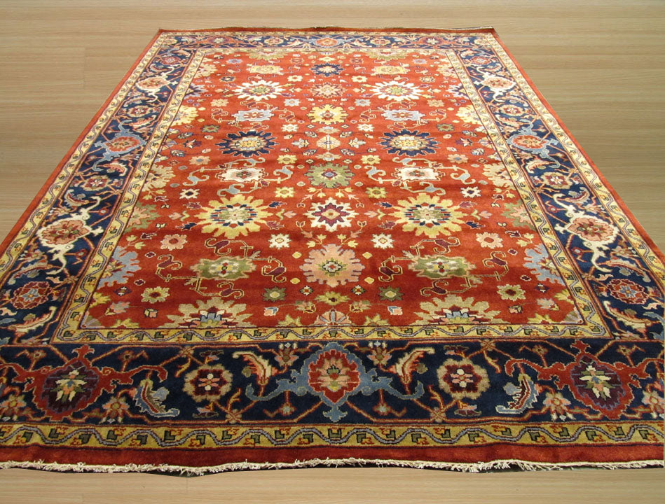 Kira Zinnia Rust Hand Knotted Wool Rug, vibrant rust and warm neutral tones intertwine in a hand-knotted wool rug with a subtly textured zinnia-inspired design, filling the space with inviting warmth and sophisticated comfort.