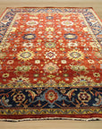 Kira Zinnia Rust Hand Knotted Wool Rug, vibrant rust and warm neutral tones intertwine in a hand-knotted wool rug with a subtly textured zinnia-inspired design, filling the space with inviting warmth and sophisticated comfort.