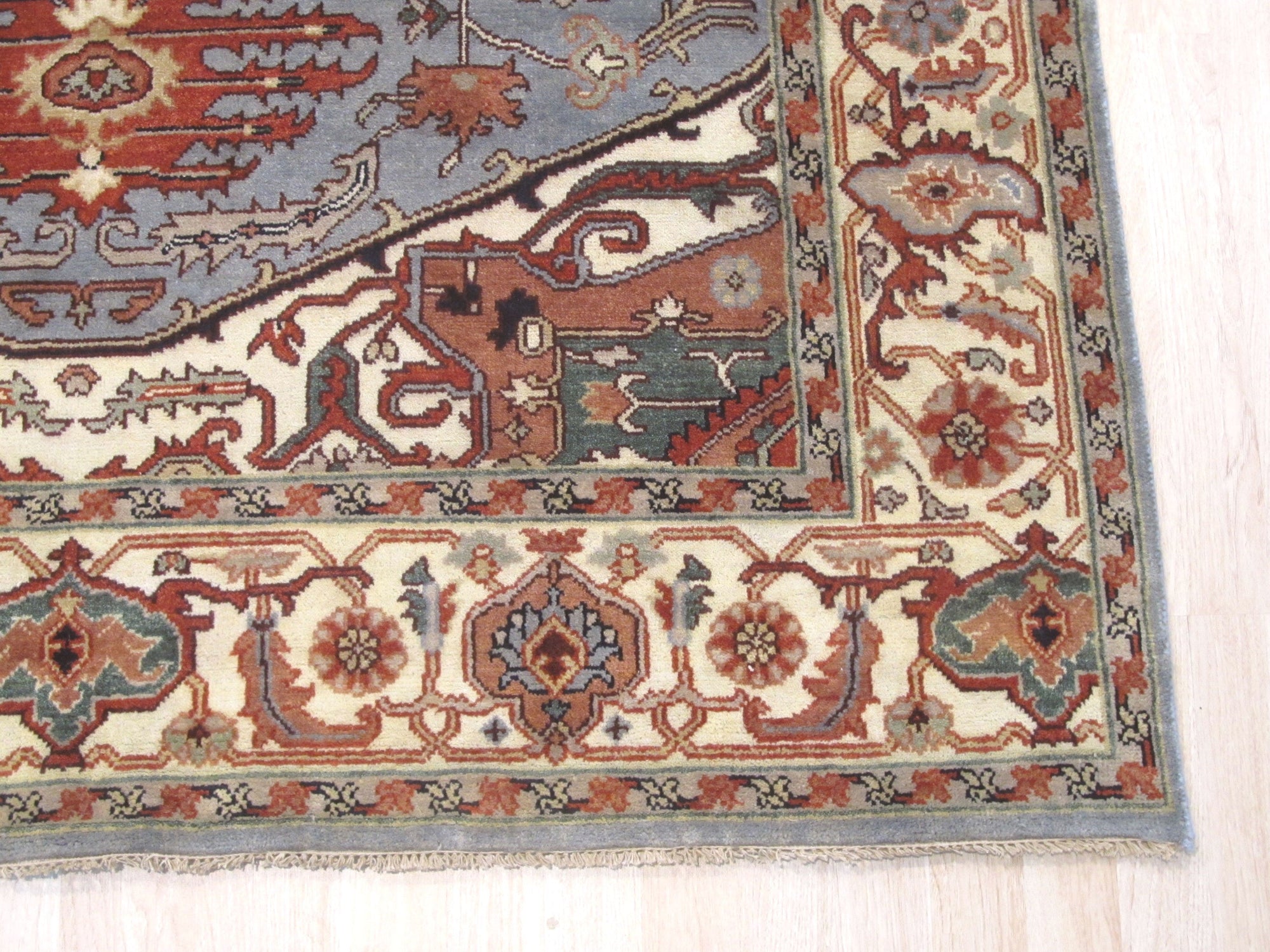 Amara Ruby Blue Hand Knotted Wool Rug, vibrant ruby and cool blue tones dance across hand-knotted wool, adding warmth and artistry to a softly lit interior space.