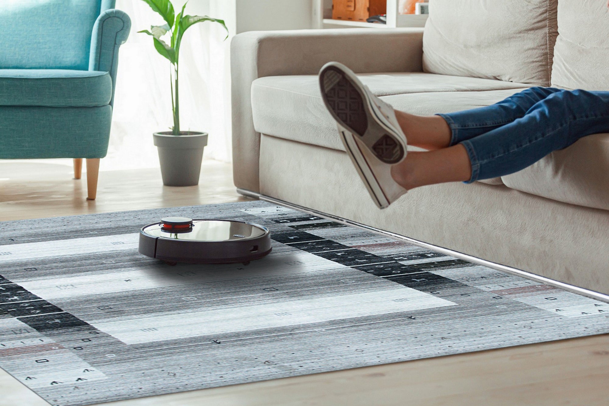 Sophie Gabbeh Gray Handmade Wool Rug, featuring a subtly textured gray field and simple, rustic design, lays elegantly on a hardwood floor, illuminated by natural light.