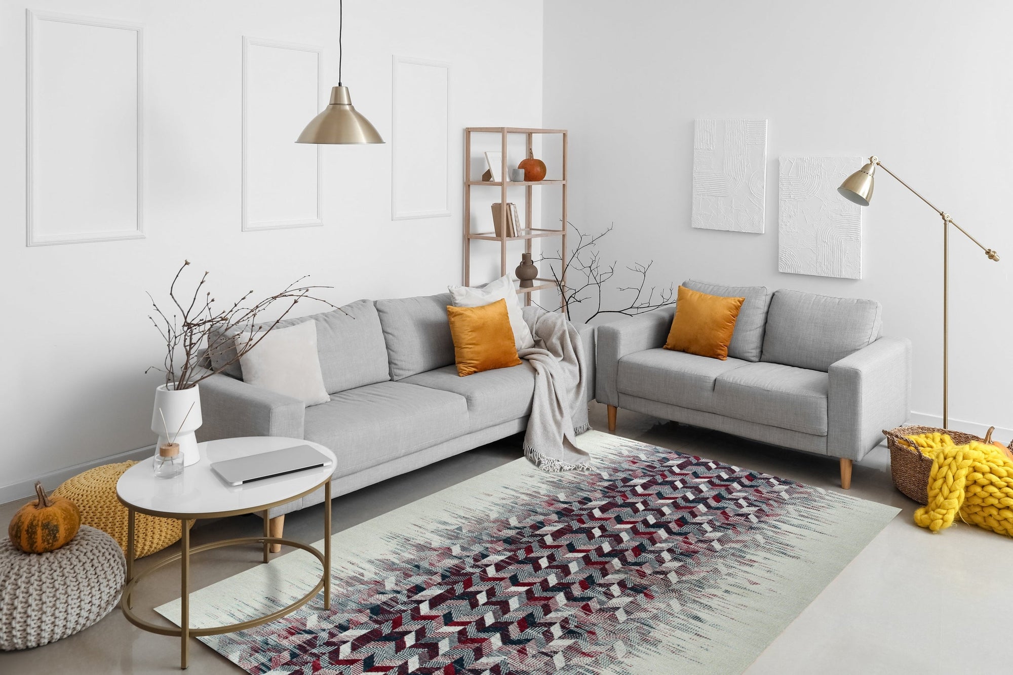 Brenda Refined Multicolor Flatweave Wool Rug, its vibrant, geometric pattern of blues, reds, yellows and creams anchoring a bright living room. Woven wool construction offers a soft, textured feel underfoot in a modern interior setting.