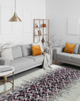 Brenda Refined Multicolor Flatweave Wool Rug, its vibrant, geometric pattern of blues, reds, yellows and creams anchoring a bright living room. Woven wool construction offers a soft, textured feel underfoot in a modern interior setting.
