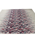 Brenda Refined Multicolor Flatweave Wool Rug, a vibrant burst of color and texture brings warmth to a modern living space. Flatweave construction showcases a complex interplay of reds, blues, greens, and yellows in an abstract geometric pattern.