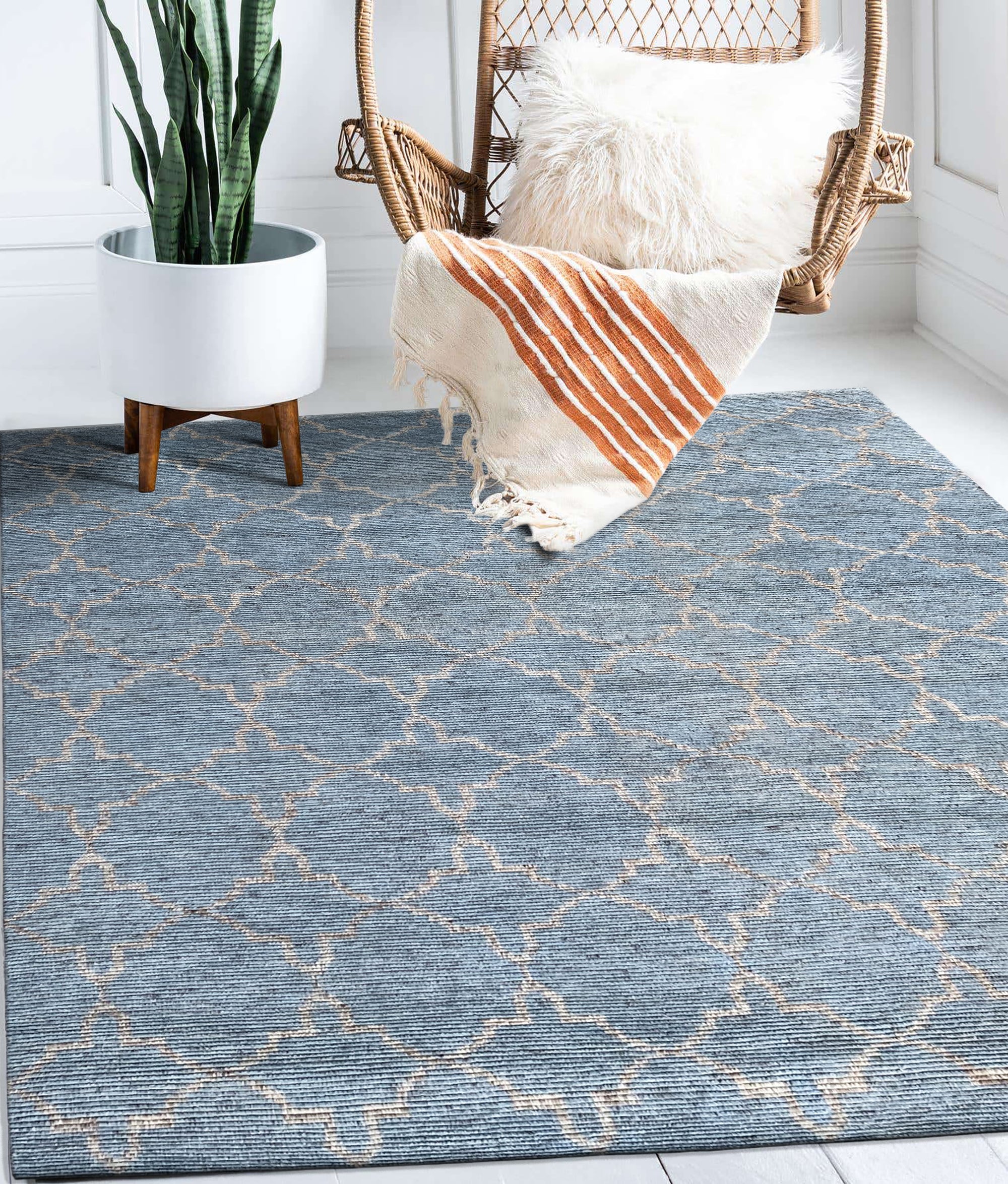 Versatile Agra Blue Hand Knotted Wool Rug, its intricate floral pattern in shades of blue and cream graces a light hardwood floor, inviting warmth and traditional elegance into the living space.