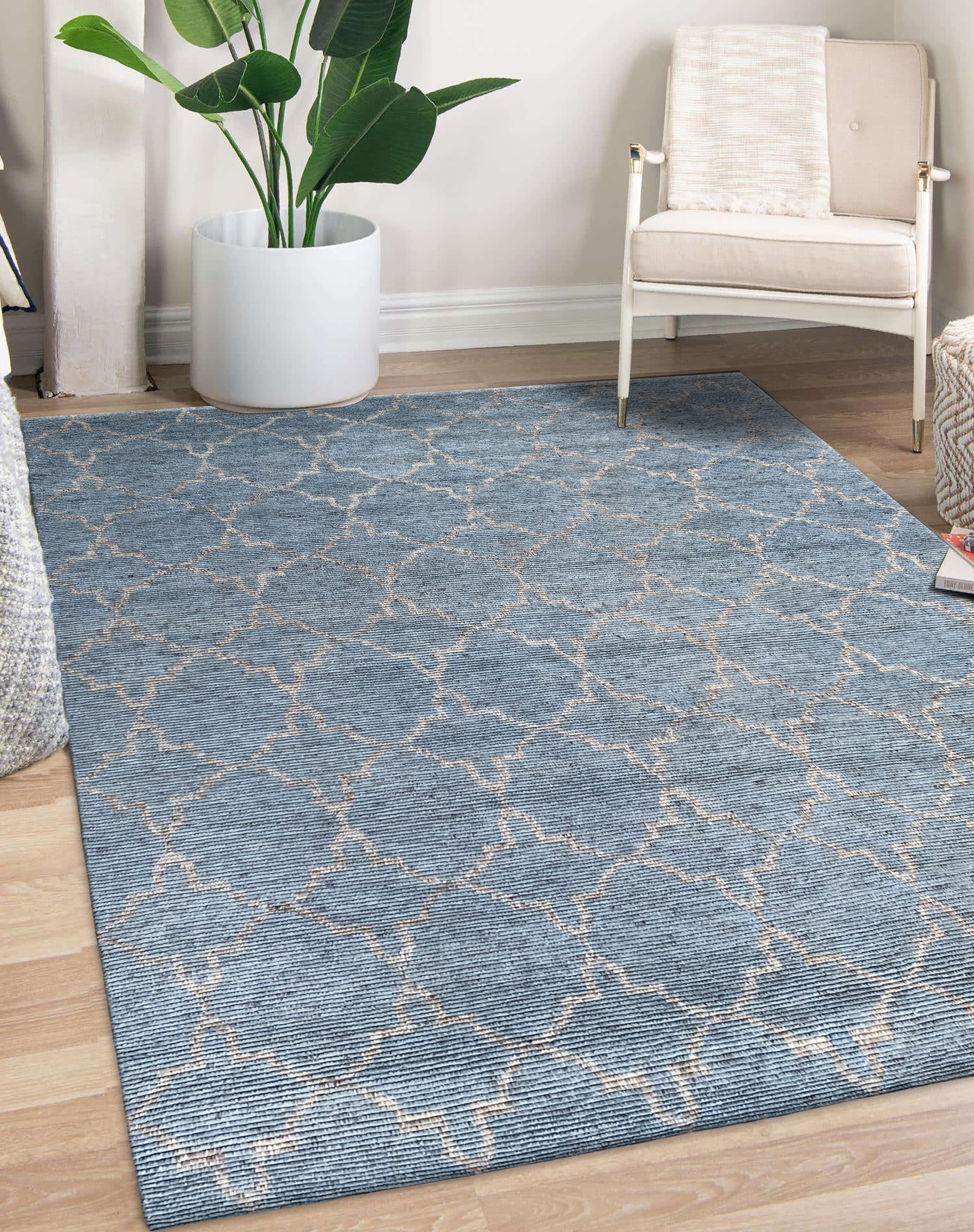 Versatile Agra Blue Hand Knotted Wool Rug, showcasing a detailed traditional pattern in varying shades of blue and cream, seen in a well-lit room setting with neutral furniture.