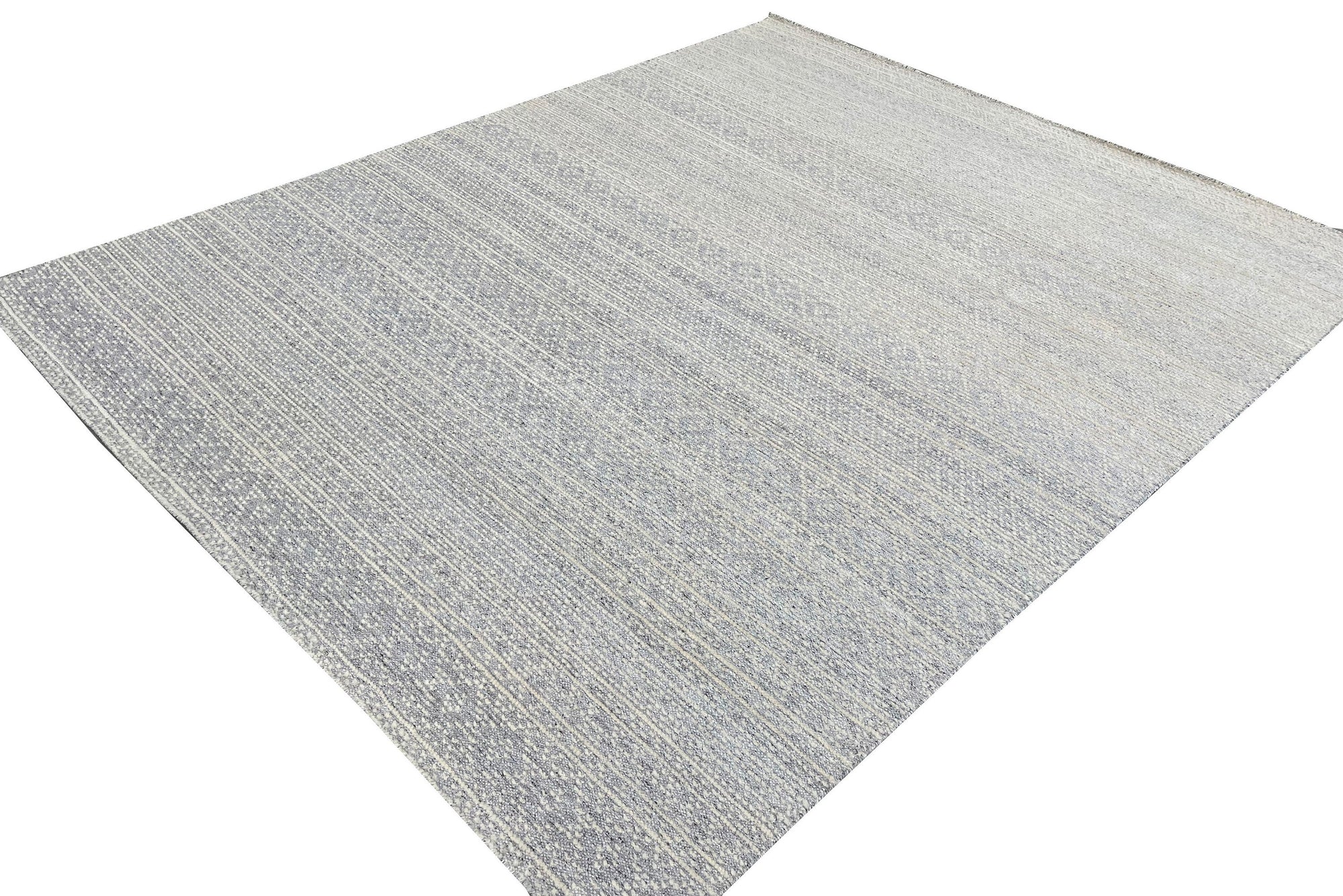 Bianca Louie Ivory Handmade Wool Rug layered beneath a light wood coffee table, styled in a bright, airy living room. The rug's soft ivory tones and subtle textural details complement the minimalist décor.