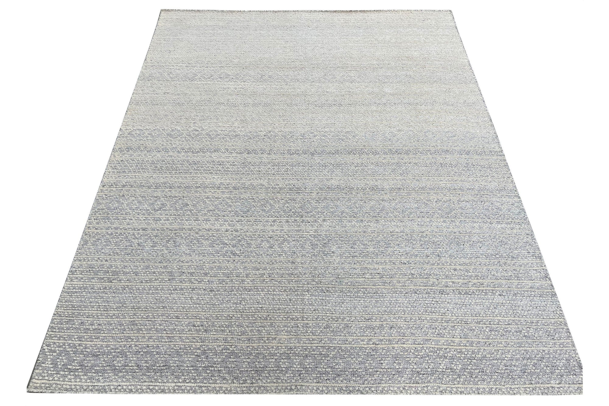 Bianca Louie Ivory Handmade Wool Rug, its soft ivory tones and hand-knotted texture lending warmth to a bright, airy living space with natural wood accents.