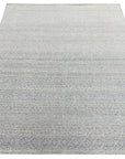 Bianca Louie Ivory Handmade Wool Rug, its soft ivory tones and hand-knotted texture lending warmth to a bright, airy living space with natural wood accents.