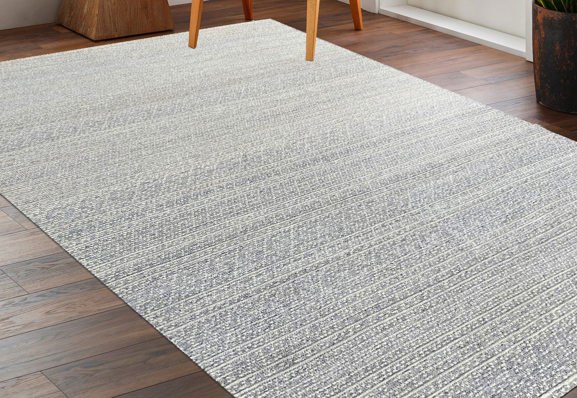 Bianca Louie Ivory Handmade Wool Rug, textured weave in soft ivory tones, fills the frame with its luxurious wool construction, showcasing intricate details.