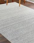 Bianca Louie Ivory Handmade Wool Rug, textured weave in soft ivory tones, fills the frame with its luxurious wool construction, showcasing intricate details.