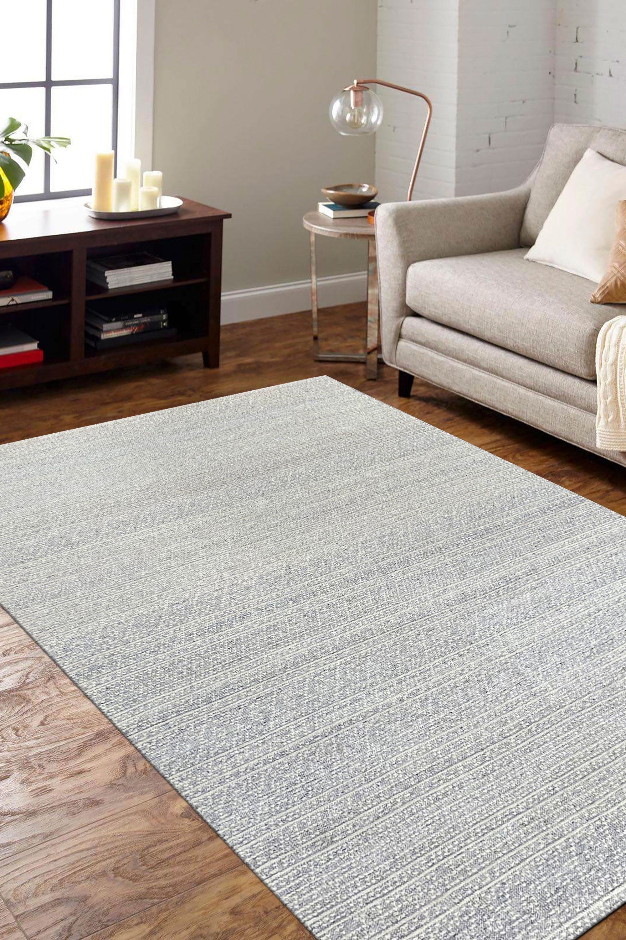Bianca Louie Ivory Handmade Wool Rug, showcasing its luxurious pile and subtle texture, laid on a light wooden floor, its neutral tones creating a calming, elegant space.