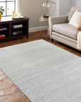 Bianca Louie Ivory Handmade Wool Rug, showcasing its luxurious pile and subtle texture, laid on a light wooden floor, its neutral tones creating a calming, elegant space.