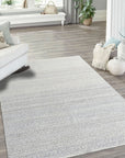 Bianca Louie Ivory Handmade Wool Rug, soft texture and intricate pattern detail visible under warm, inviting light; a testament to its handcrafted construction.
