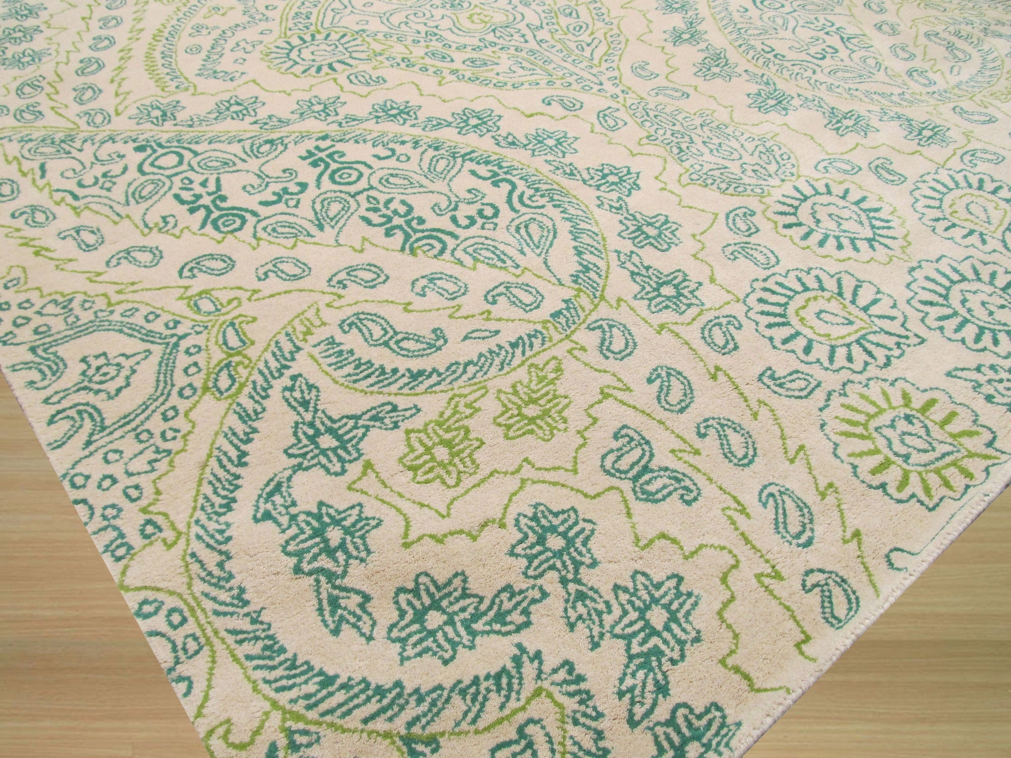 Beautiful Alluring Green Hand Tufted Wool Rug, a lush expanse of deep emerald and lighter sage tones, hand-tufted for rich texture, seen adding warmth and elegance to a well-lit room.