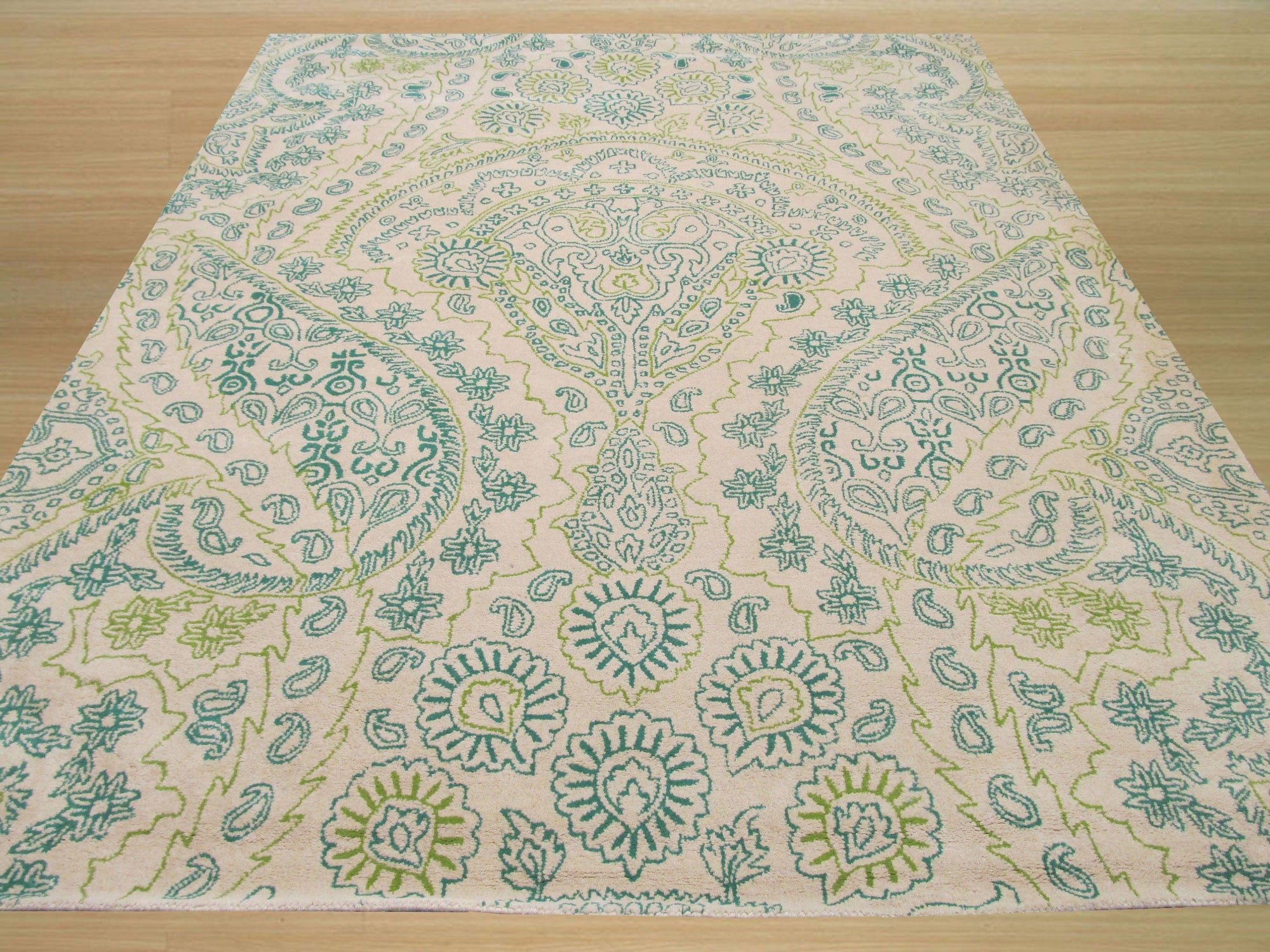 Beautiful Alluring Green Hand Tufted Wool Rug, its lush green hues and hand-tufted texture creating a welcoming atmosphere, lays elegantly in a brightly lit room.
