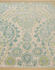 Beautiful Alluring Green Hand Tufted Wool Rug, its lush green hues and hand-tufted texture creating a welcoming atmosphere, lays elegantly in a brightly lit room.
