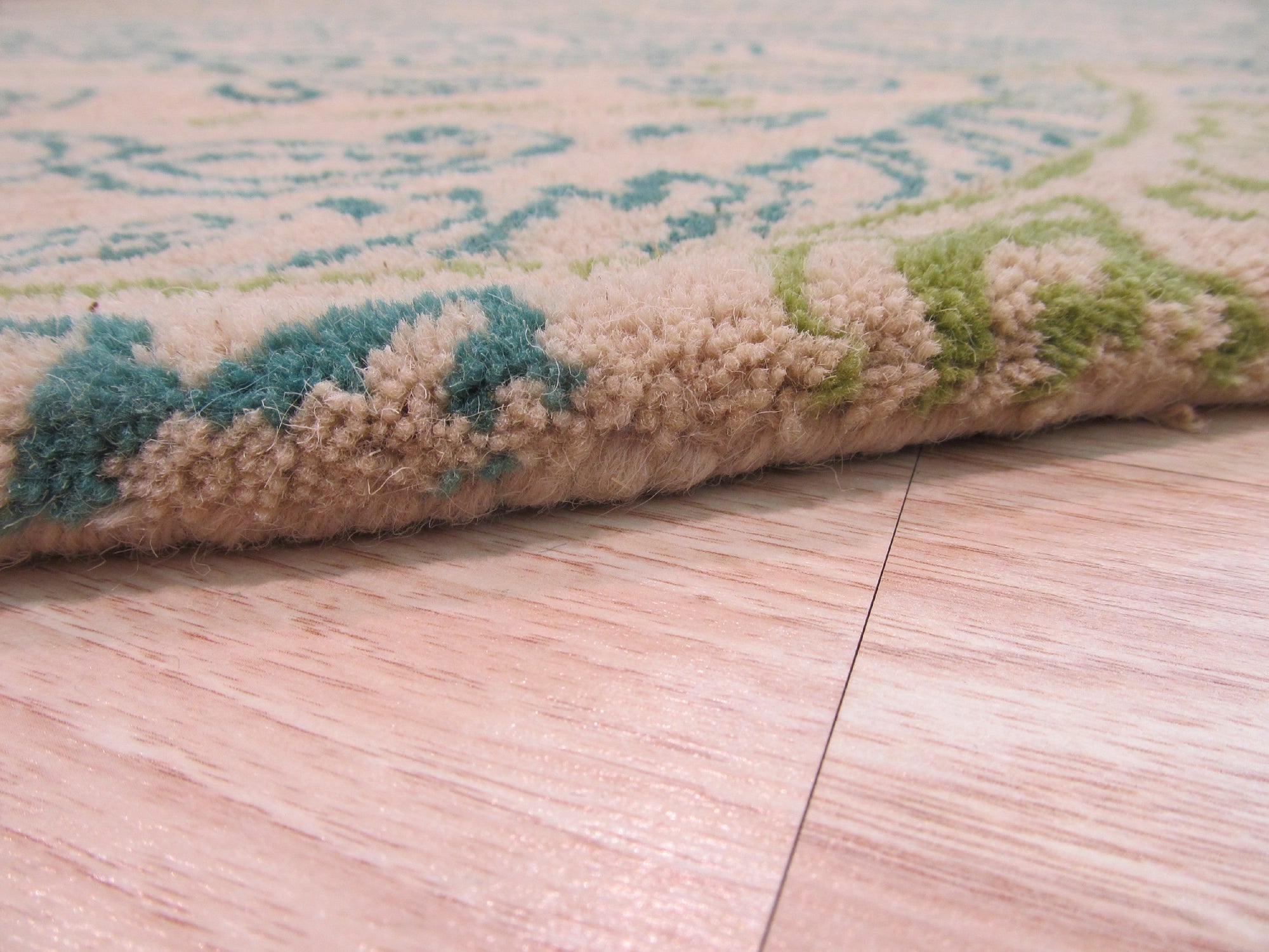 Beautiful Alluring Green Hand Tufted Wool Rug, a lush emerald expanse lending warmth and texture to a modern living space with light wood floors and minimalist furniture.