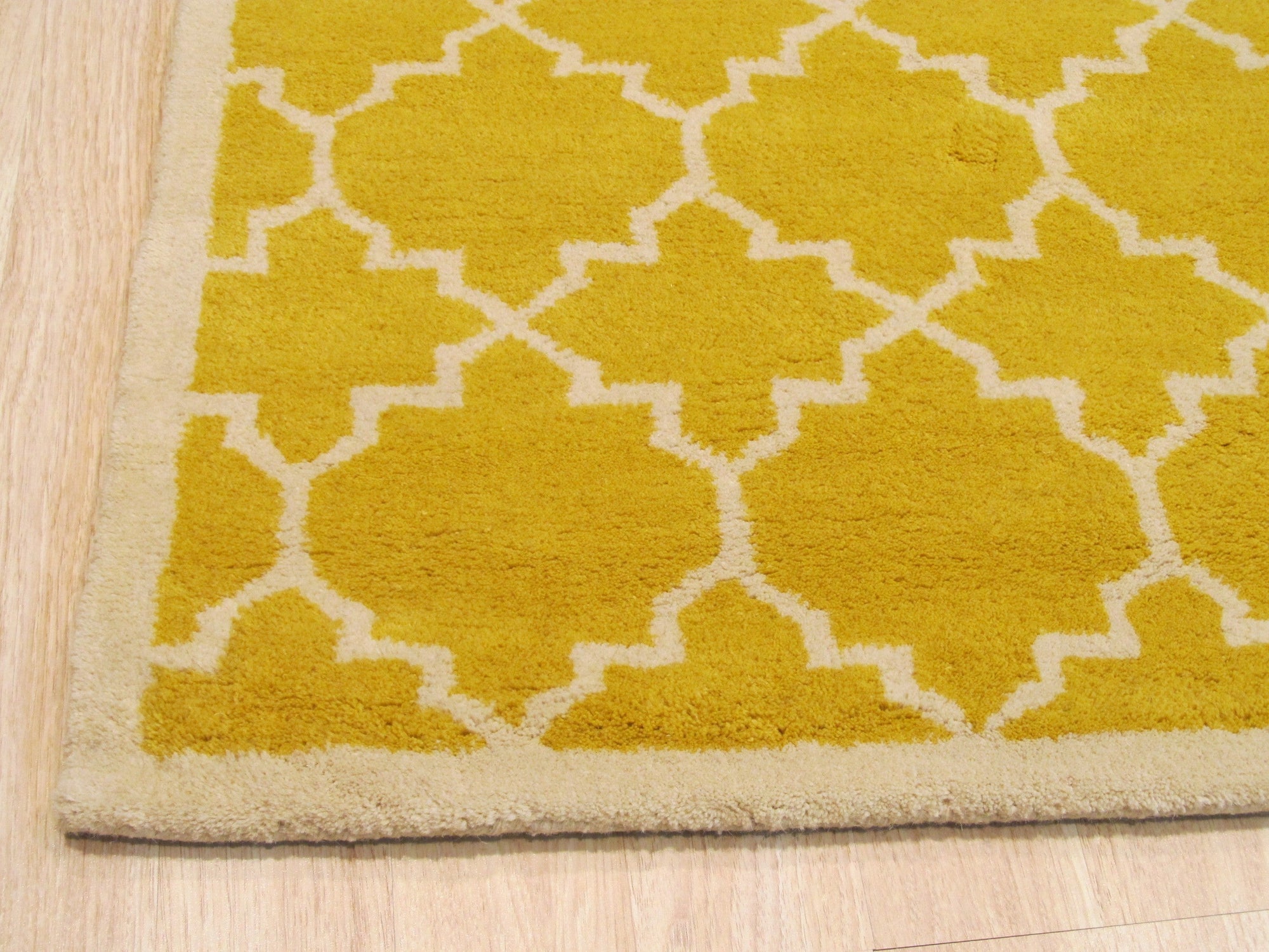 Enchanting Vibrant Yellow Hand Tufted Wool Rug, a bright yellow wool rug with a dense, plush texture, seen styled in a living room setting with modern furniture.