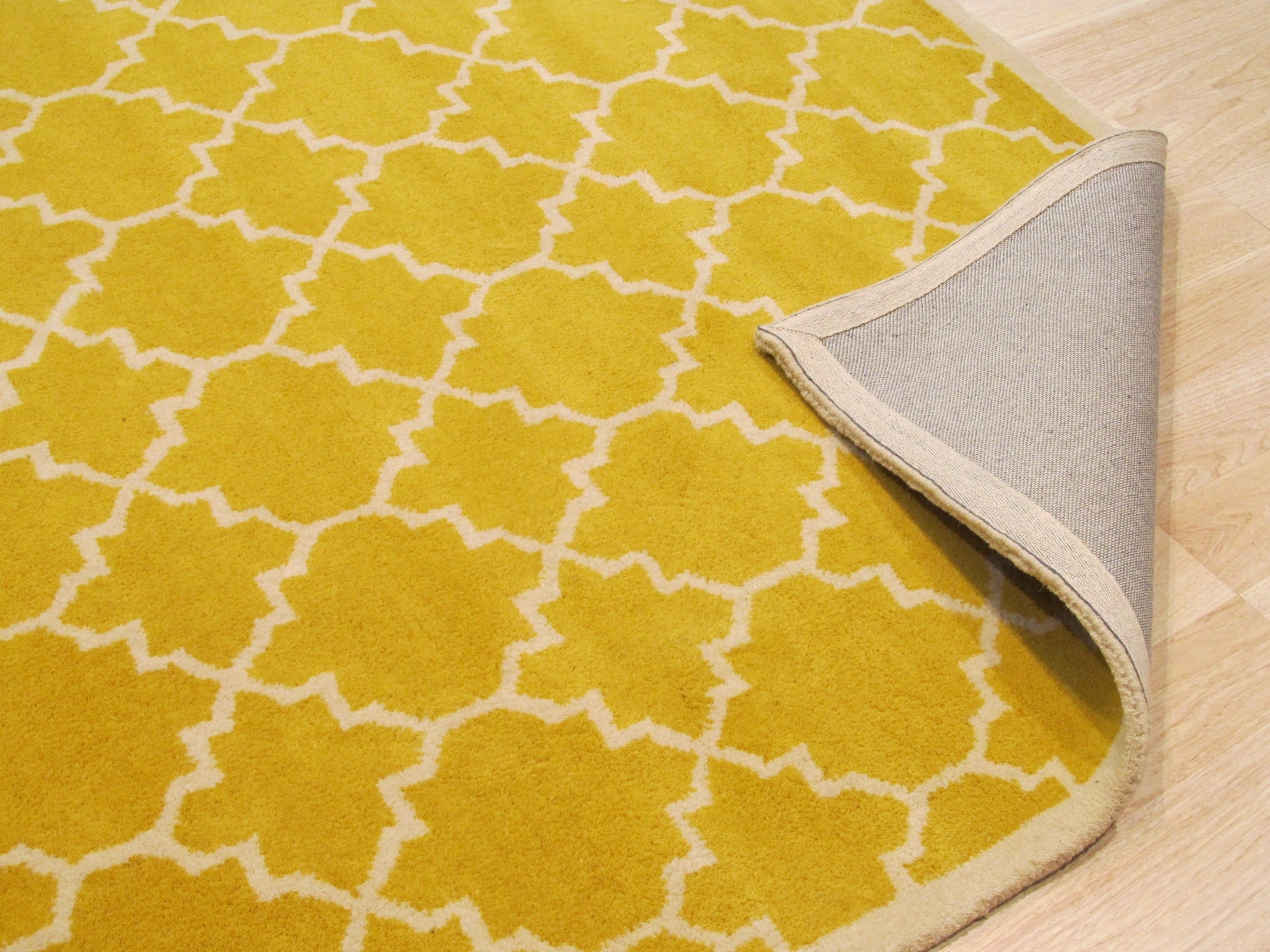 Enchanting Vibrant Yellow Hand Tufted Wool Rug, a bright yellow wool rug with a subtly textured surface, seen displayed to showcase its color and weave.