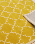 Enchanting Vibrant Yellow Hand Tufted Wool Rug, a bright yellow wool rug with a subtly textured surface, seen displayed to showcase its color and weave.
