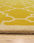 Enchanting Vibrant Yellow Hand Tufted Wool Rug, a sunny, textured statement piece, adds warmth to a bright, modern living room with natural wood accents.