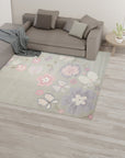 Rustic Elena Gray Hand Tufted Wool Rug, its subtle gray tones and textured wool surface lending warmth to a modern living room with light wood floors and minimalist furnishings.