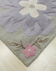 Rustic Elena Gray Hand Tufted Wool Rug, blending muted gray tones with a subtly textured, hand-tufted construction, graces a light-filled room, adding warmth and understated elegance to the décor.