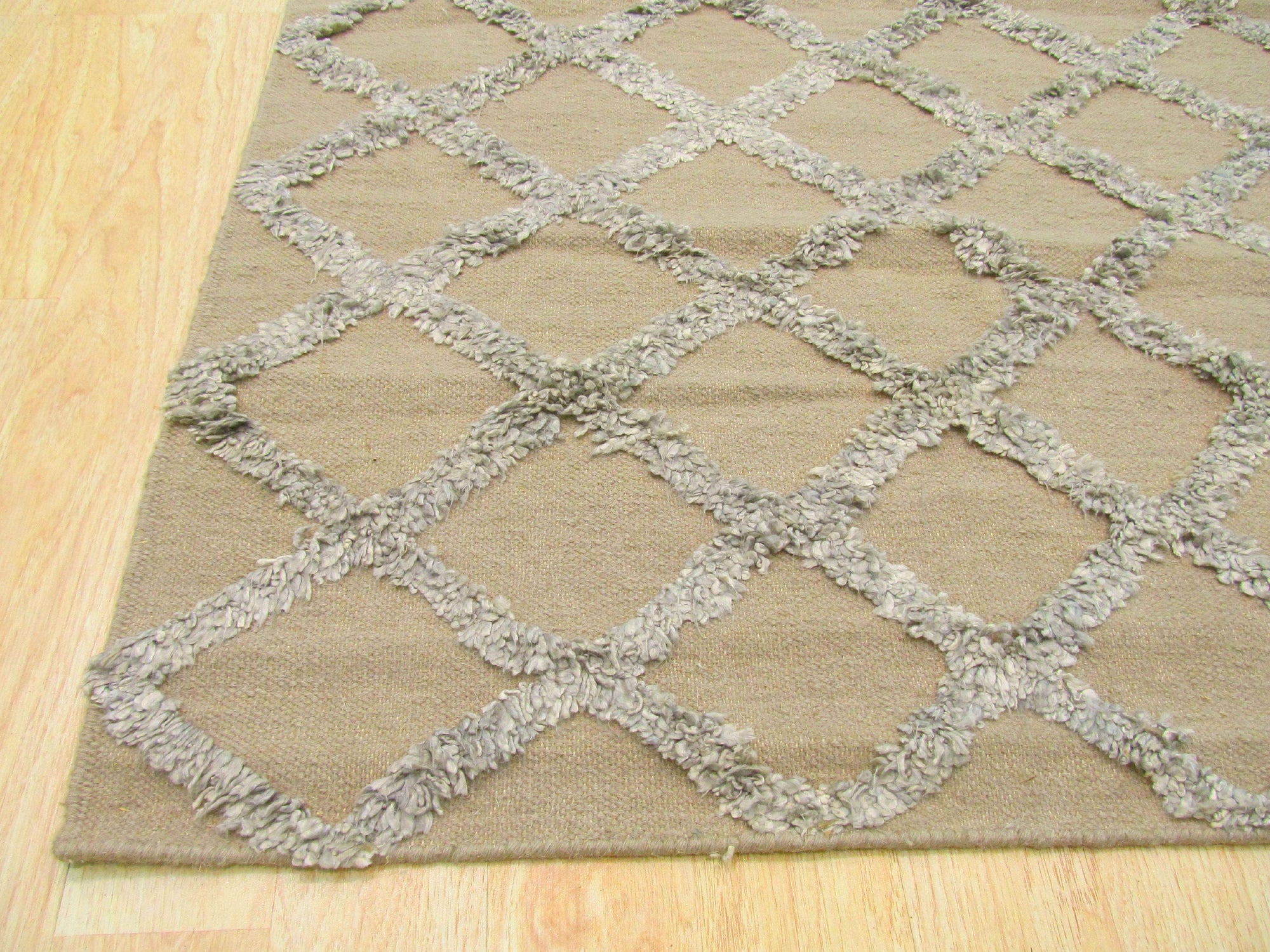 Chic Marrakesh Camel Hand Knotted Wool & Viscose Rug, showcasing a neutral camel palette and intricate geometric patterns. Hand-knotted construction evident in the plush texture, hinting at both wool and viscose materials. Subtle sheen reflects light, highlighting the luxurious feel and detailed design.