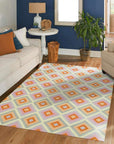 Jasmine Vibrant Multicolor Flatweave Wool Rug displayed in a well-lit room, its colorful geometric pattern adding a lively touch to the hardwood floor. Flatweave construction highlighted by the light.