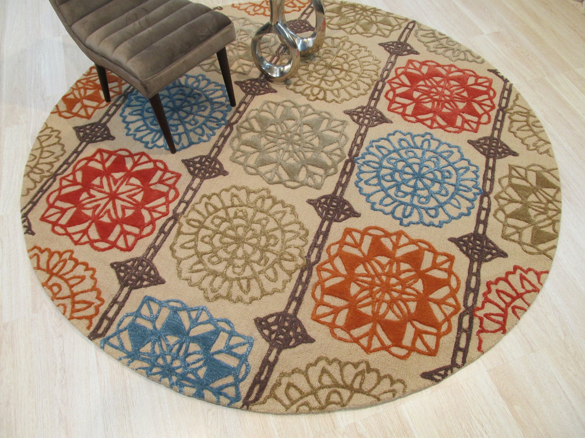 Artistic Sumptuous Beige Hand Tufted Wool Rug, a beige wool rug with a textured, almost organic pattern, partially visible in a bright, modern living space.