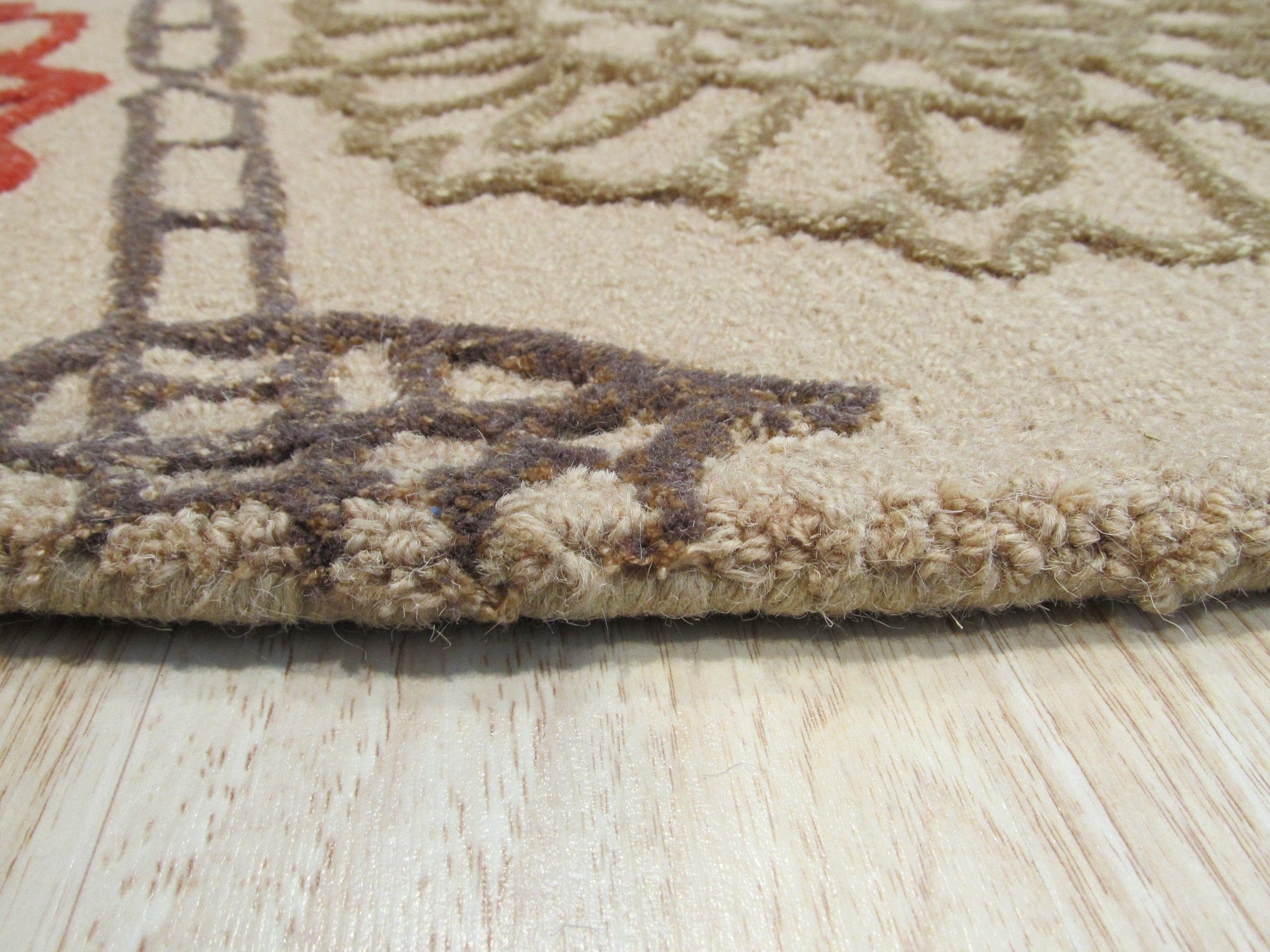 Artistic Sumptuous Beige Hand Tufted Wool Rug, creamy beige expanse of hand-tufted wool, displaying subtle textural variations and inviting warmth.