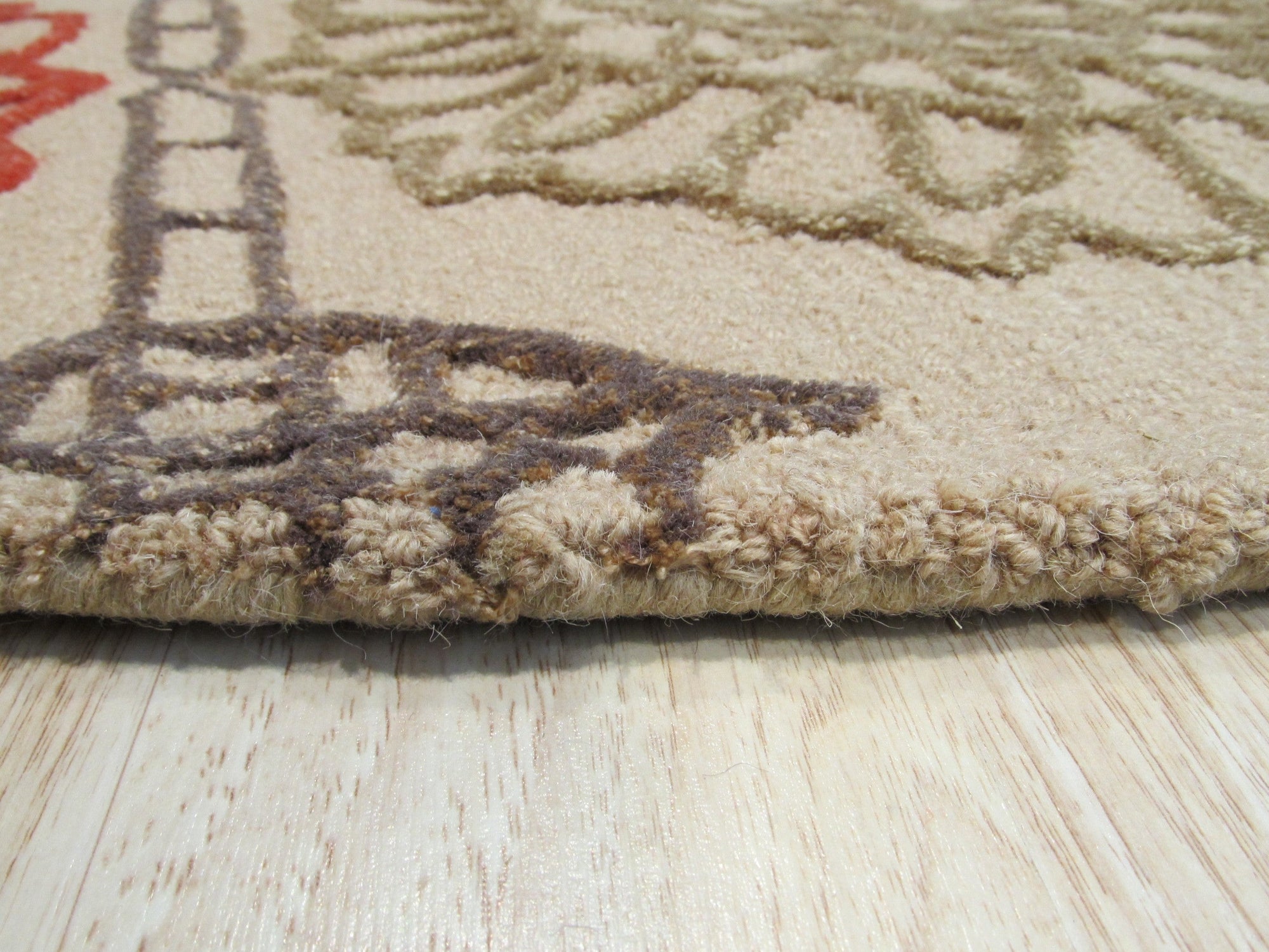 Artistic Sumptuous Beige Hand Tufted Wool Rug, its plush beige wool texture and hand-tufted construction evident, displayed as part of a larger room setting.