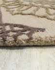 Artistic Sumptuous Beige Hand Tufted Wool Rug, its plush beige wool texture and hand-tufted construction evident, displayed as part of a larger room setting.
