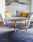 Stylish Timeless Blue Hand Tufted Wool Rug, featuring a classic design in shades of blue and cream, positioned on a light hardwood floor creating a warm and inviting space.
