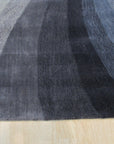 Stylish Timeless Blue Hand Tufted Wool Rug, showcases a textured blue field detailed with subtle variations, hand-tufted wool pile adding depth and warmth to the setting.