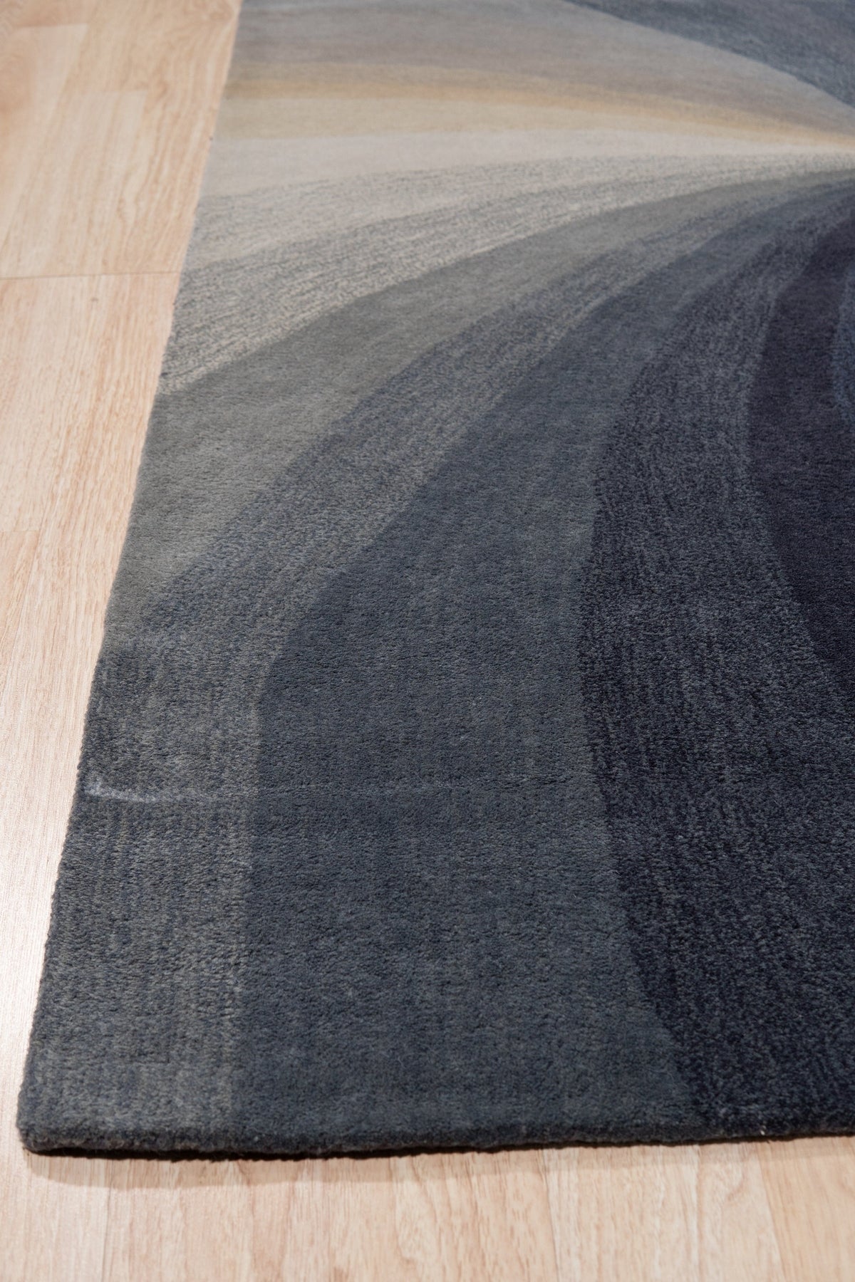 Stylish Timeless Blue Hand Tufted Wool Rug, a plush indigo and cream wool rug with a geometric pattern, softening a modern living room.
