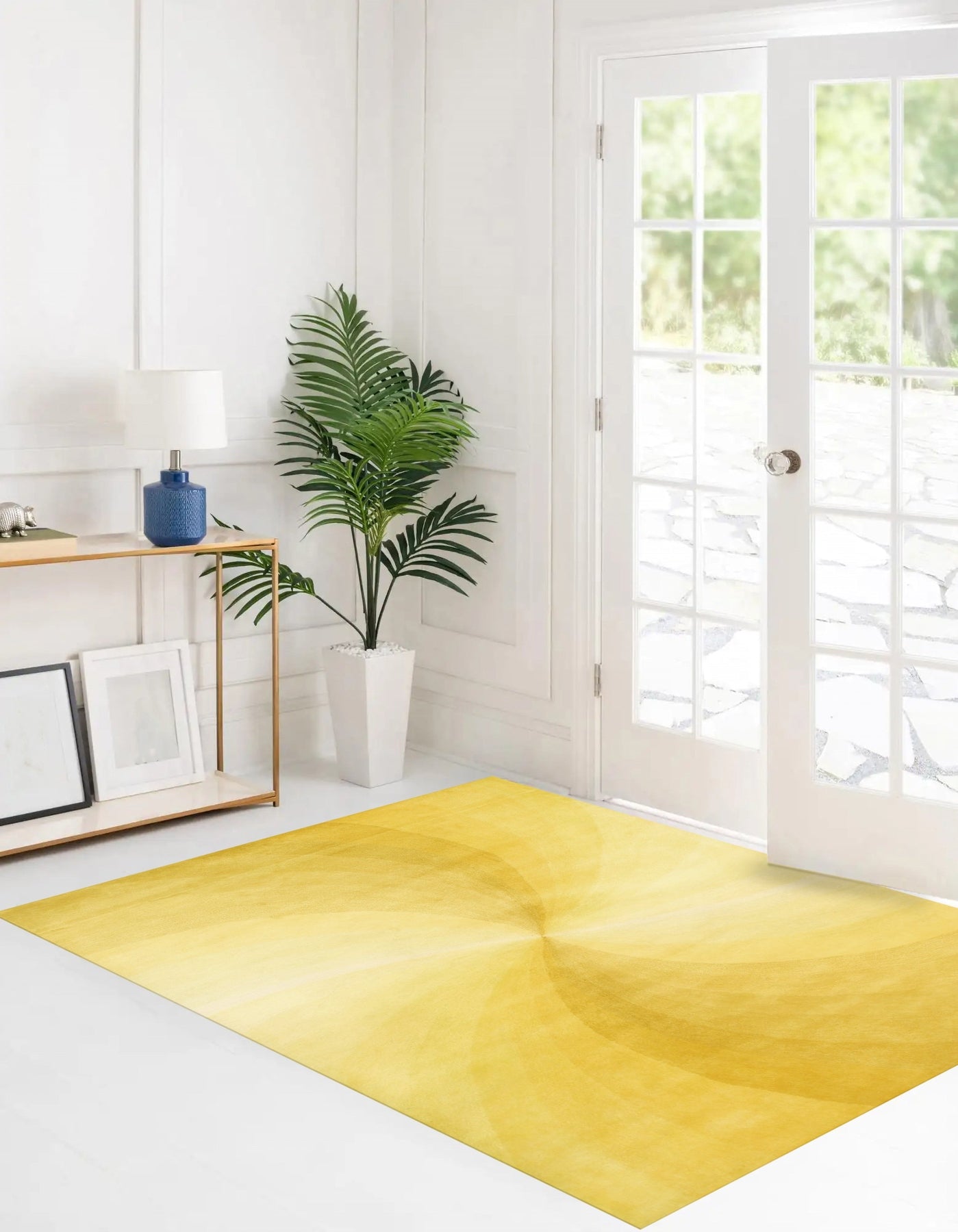 Brenda Chic Yellow Hand Tufted Wool Rug, radiating warmth and texture in a brightly lit interior. Its hand-tufted wool construction showcases subtle variations in the sunny yellow hue, complemented by a minimalist, chic design.