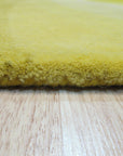 Brenda Chic Yellow Hand Tufted Wool Rug, a vibrant yellow wool rug with a chic design, displayed in a bright, airy room setting.