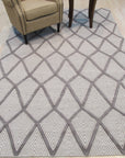 Trendy Diamond Gray Hand Knotted Wool Rug, soft gray and ivory diamonds dance across a hand-knotted wool rug, lending subtle texture and modern elegance to a warmly lit living space.