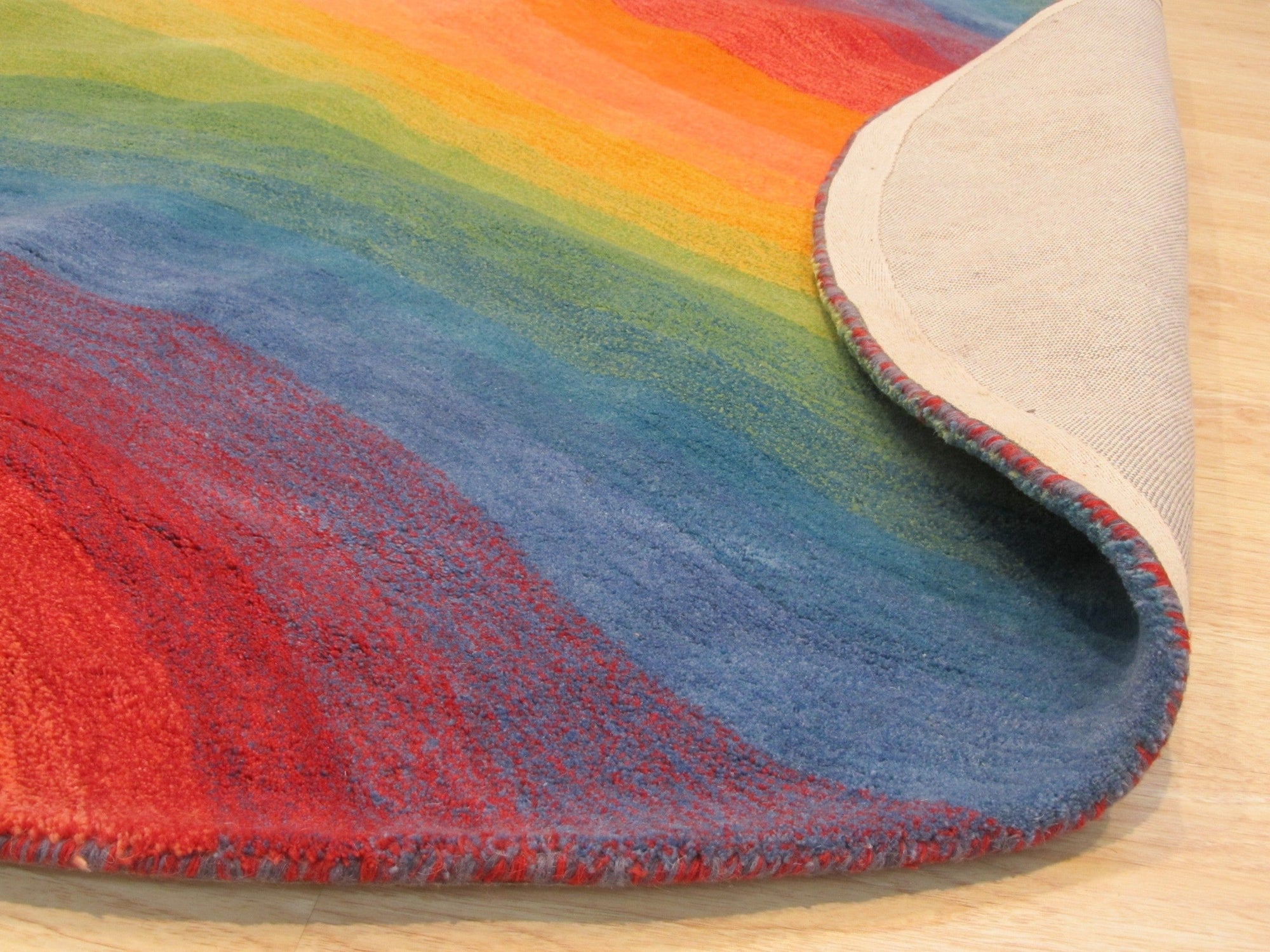 Vibrant Dazzling Multicolor Hand Tufted Wool Rug, a kaleidoscope of bold hues in a plush wool pile, energizes a contemporary living space.