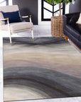 Xena Violet Blue Hand Tufted Wool Rug, a blend of deep violet and cool blue hues, displaying a subtle textured pattern. Seen in a bright, modern living space adding a touch of soft luxury.