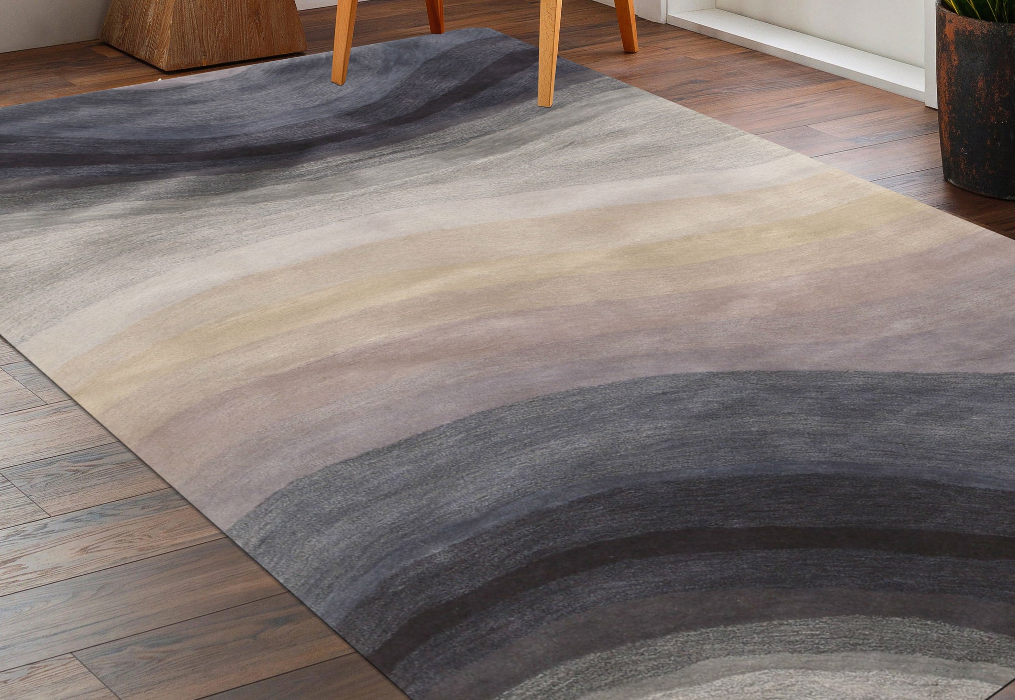 Xena Violet Blue Hand Tufted Wool Rug, blends violet and blue hues in a hand-tufted wool construction, creating a sophisticated and textured floor covering in a styled room setting.
