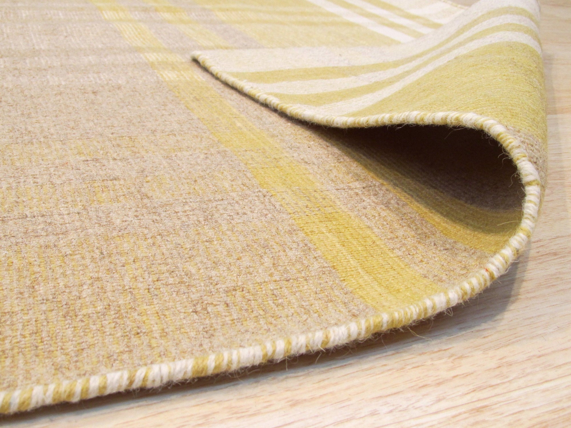Chic Serene Yellow Flatweave Wool Rug, brightening a modern living space with its subtle yellow tones and flatweave texture.