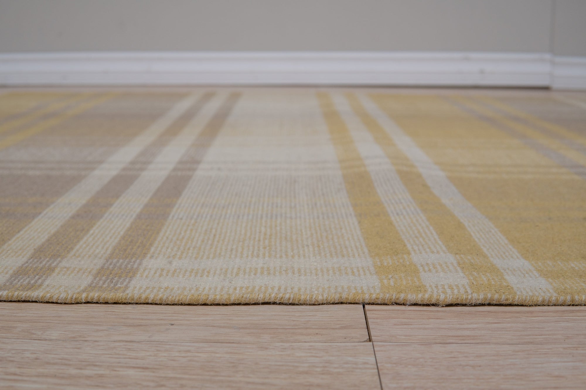 Chic Serene Yellow Flatweave Wool Rug, soft yellow tones and flatweave texture create a serene atmosphere in a room setting.