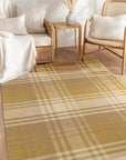 Chic Serene Yellow Flatweave Wool Rug gracing a light-filled living room. Pale wood floors accentuate its subtle yellow hues and flatweave texture, adding a touch of warmth and serenity to the modern space.
