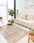 Sarrah Delicate Gold Flatweave Wool Rug, bathed in warm light, reveals subtle gold tones interwoven within a neutral palette, flatwoven construction lending a refined texture to the floor in a casually elegant living space.