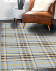 Jade Dahlia Blue Flatweave Wool Rug, displaying intricate dahlia floral motifs woven into a calming blue and ivory palette, resting beautifully on a hardwood floor.