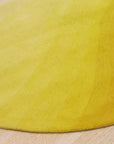 Inviting Ruby Yellow Hand Tufted Wool Rug, displaying vibrant ruby and yellow hues in a handcrafted wool construction, set against a neutral backdrop.